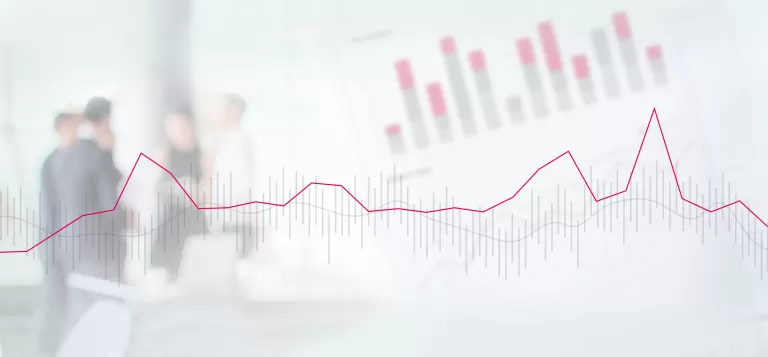 Graph mit steigender Kurve vor verschwommenen Personen in einem Büro